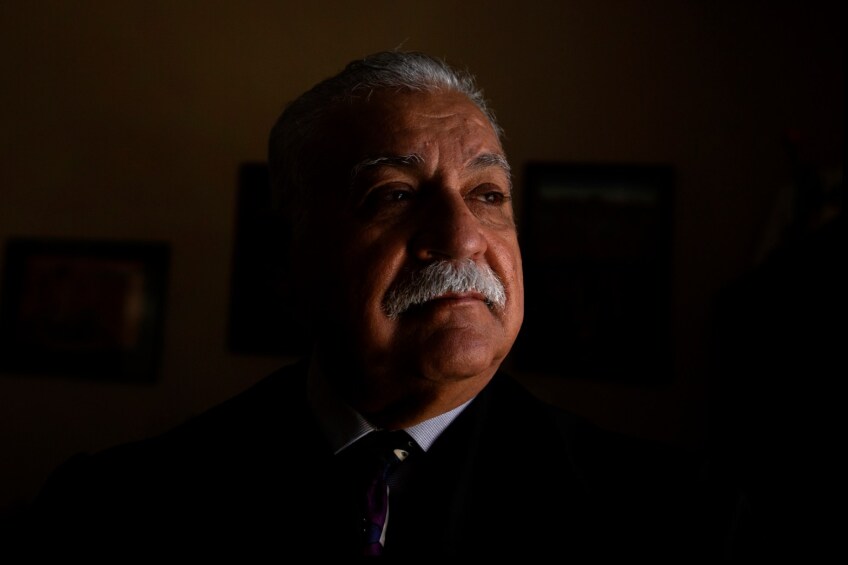 Judge Juan Ulloa stands for a portrait in his chamber at the Imperial County Superior Court. He wears his white hair short and has a white mustache.