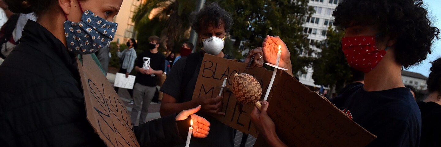 Protesters light candles during a candlelight vigil in front of Pasadena City Hall after the death of George Floyd, a black man who was in police custody in Minneapolis in Pasadena on Sunday, May 31, 2020. | (Photo by Keith Birmingham/MediaNews Group