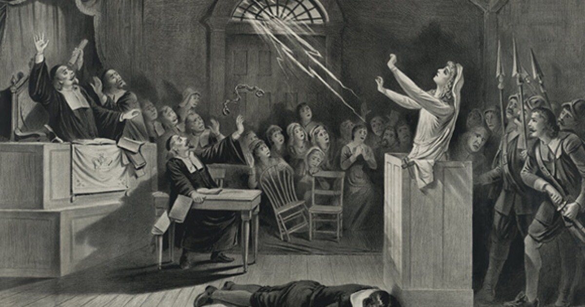 A photo of a representation of the Salem witch trials by Joseph E. Baker.
Shows a woman standing on trial for witchcraft