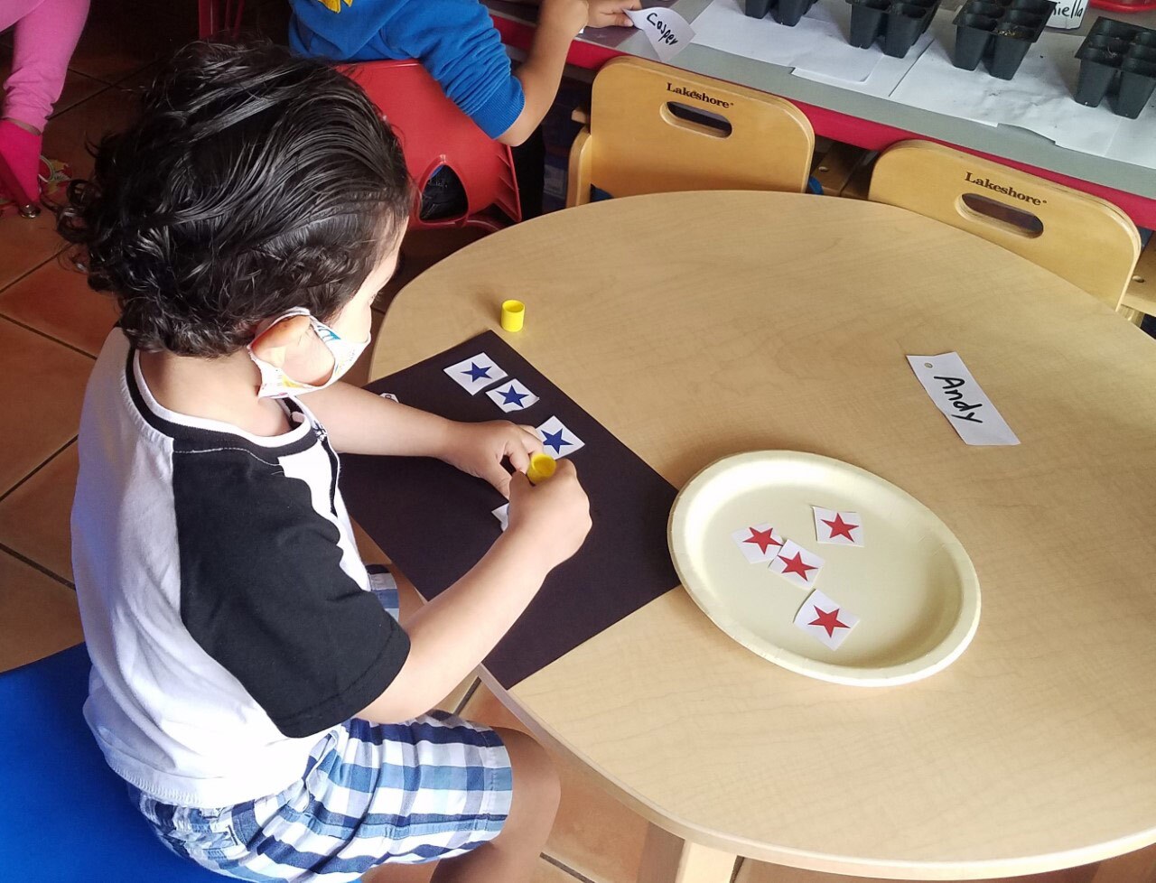 A small child sorts stars at a day care that took part in a pilot hybrid program from PBS SoCal focused on early science and math.