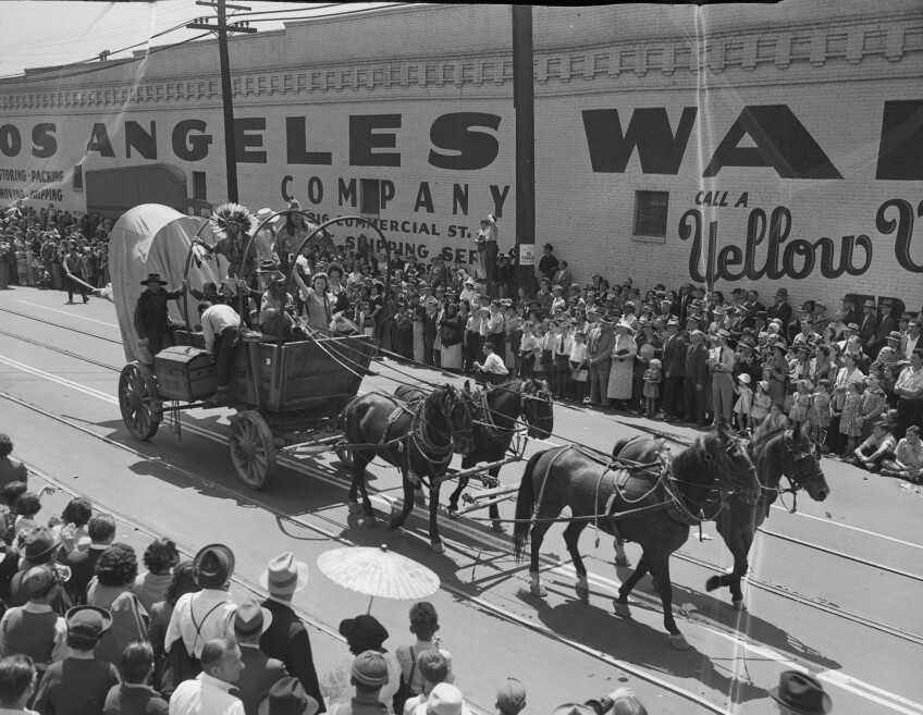 A family on a stagecoach canter down the parade in celebration of L.A. Union Station's opening.