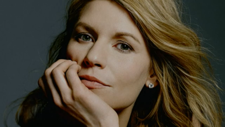 A portrait of Claire Danes, with her resting her chin on her hand.