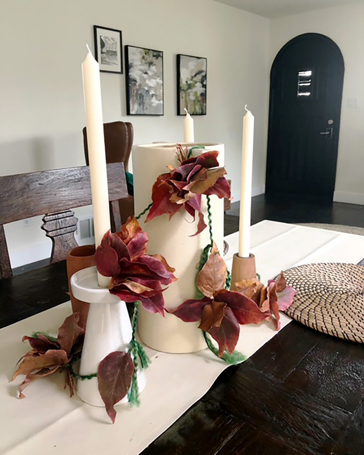 The fall leaves garland adorns a table.