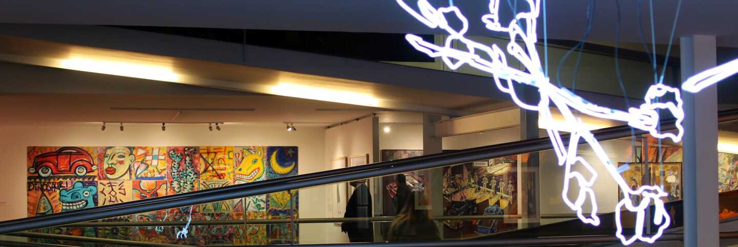 "Bridges in a Time of Walls" exhibition wide shot. "Strewn" by Leticia Maldonando in the foreground with "Los Four 20th Anniversary Collective Mural" in the background. | Samanta Helou Hernandez