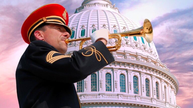 A person in uniform plays an instrument in front of the Capitol building.