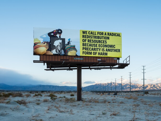 Another one of Simmons' billboards features a portrait of Marsha P. Johnson, a Black, trans-rights activist and prominent figure in the Stonewall uprising of 1969. It also reads, "We call for radical distribution of resources because economic precarity is another form of harm."