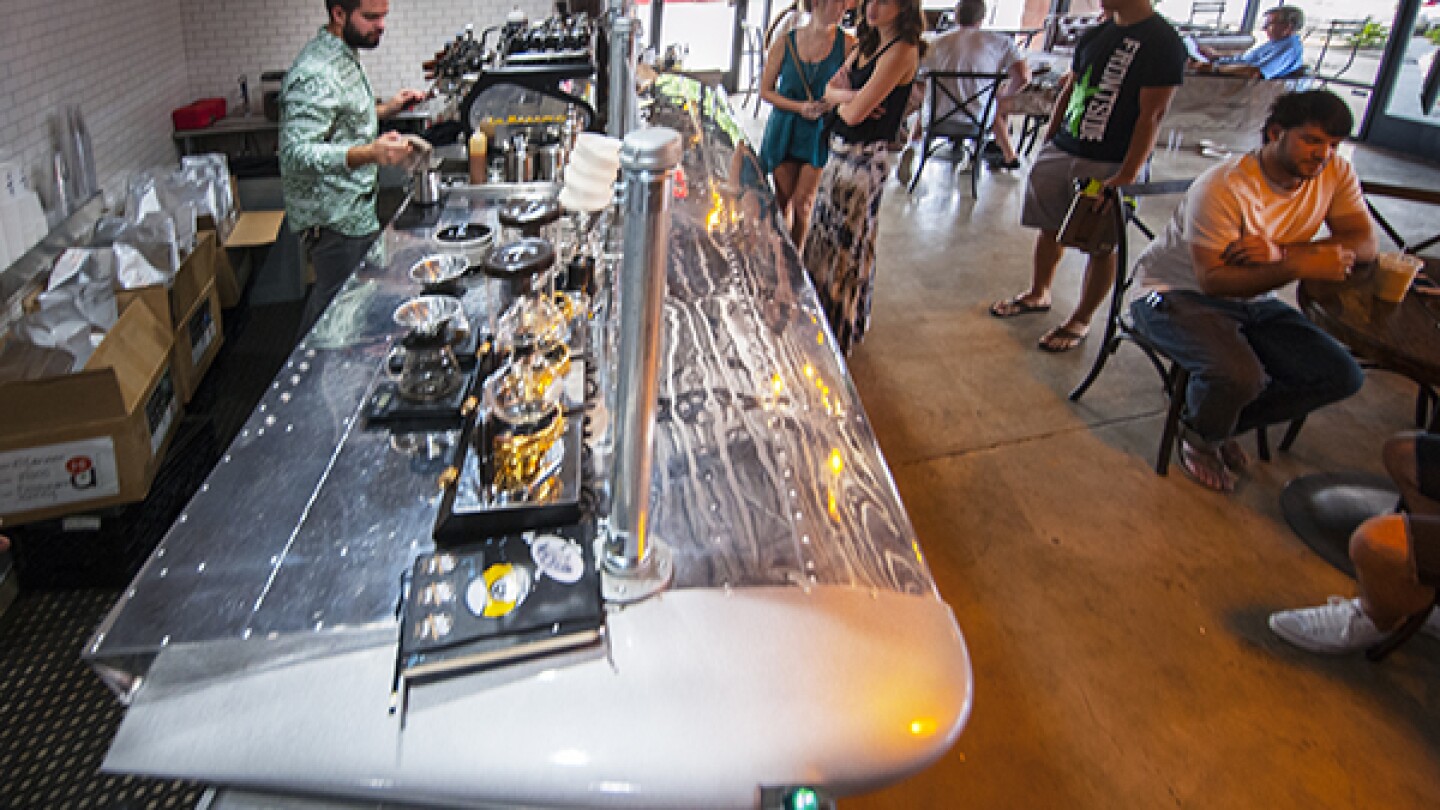 Geoff Gouveia behind an espresso bar made from a Cessna wing. | Photo: Douglas McCulloh