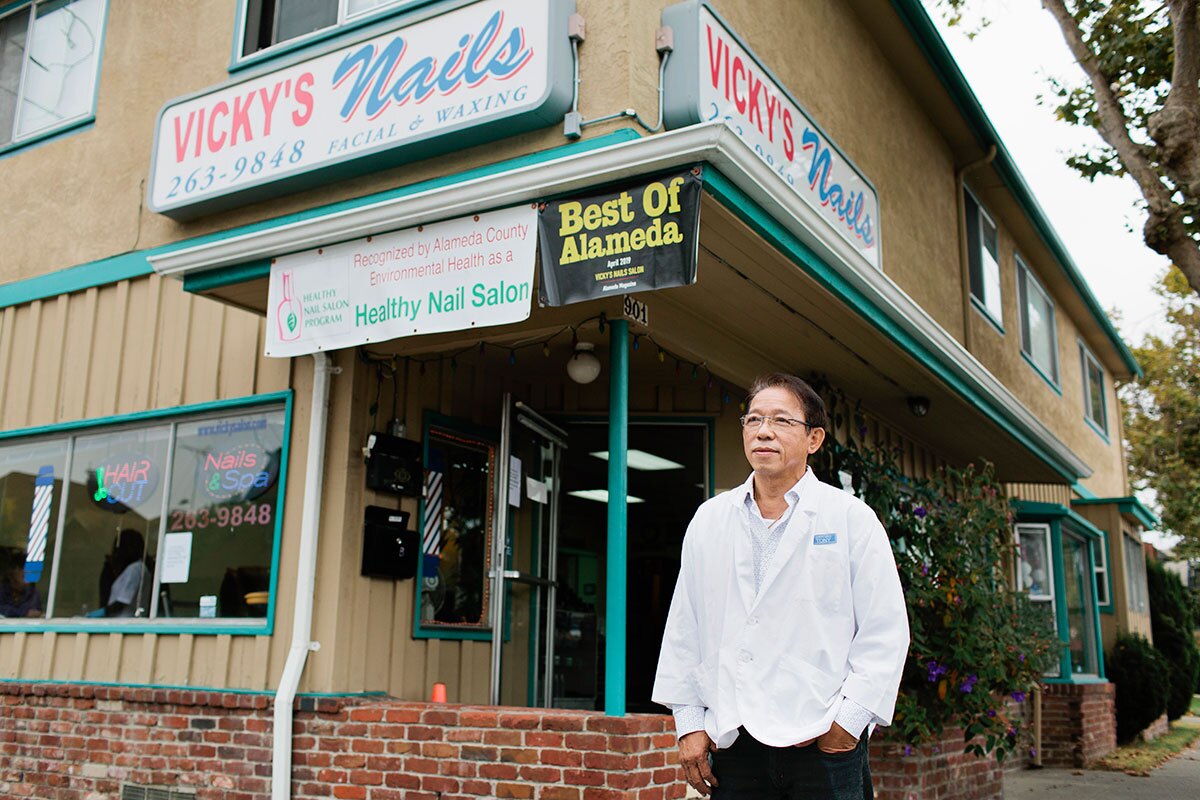 Xuan Huynh, owner of Vicky's Nail Salon, poses for a portrait outside the salon in Alameda, Calif., Wednesday, Aug. 28, 2019. He has owned the salon since 1995. | Alison Yin for KCET