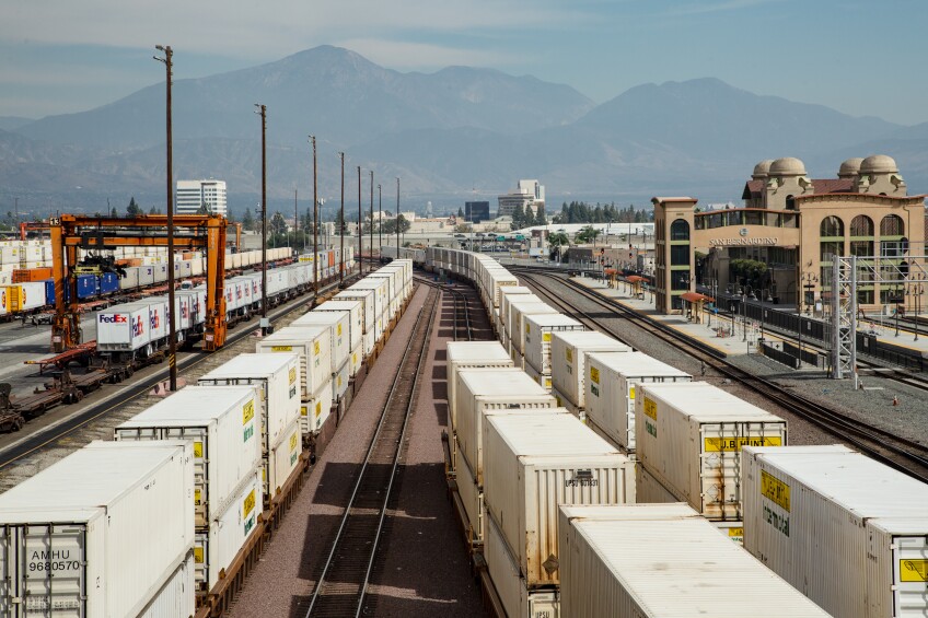 Well cars carrying shipping containers line the rails of the BNSF intermodal facility in San Bernardino, California.