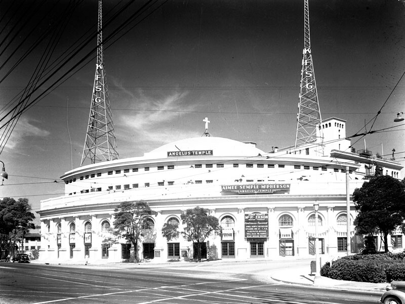 Aimee Semple McPherson’s Angelus Temple, twin towers on the roof, drew thousands of congregants to weekly services and tens of thousands more to listen her radio broadcasts.