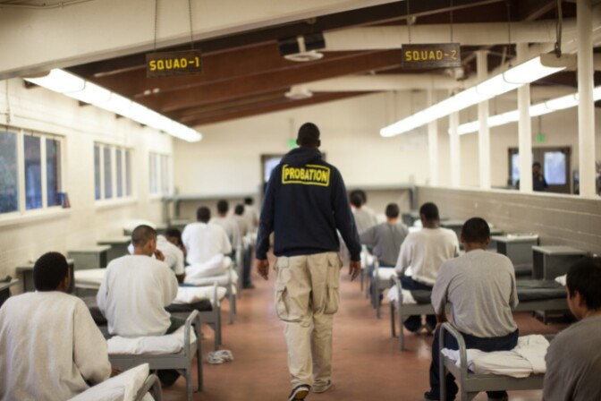 A probation officer walks through a dormitory at Camp Afflerbaugh in 2013. | Grant Slater / KPCC