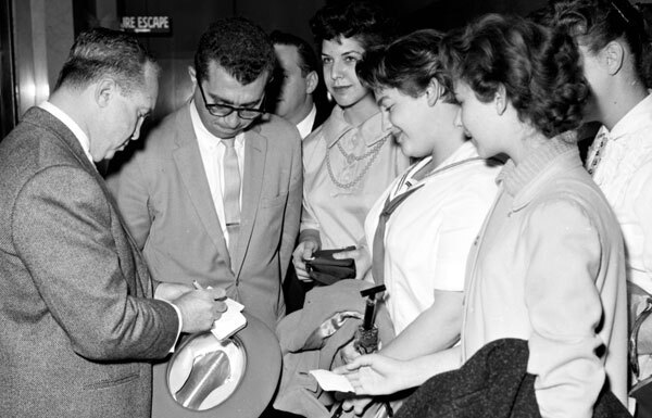Cohen signs autographs for young women from Washington High School during a 1958 trial. Courtesy of the Los Angeles Examiner Collection, USC Libraries.