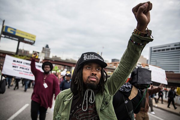 Demonstrators react after a grand jury decided not to indict a white police officer in the Ferguson, Missouri shooting death of an unarmed black teenager, November 24, 2014 in Los Angeles, Calfornia. Photo By: RINGO CHIU/AFP/Getty Images