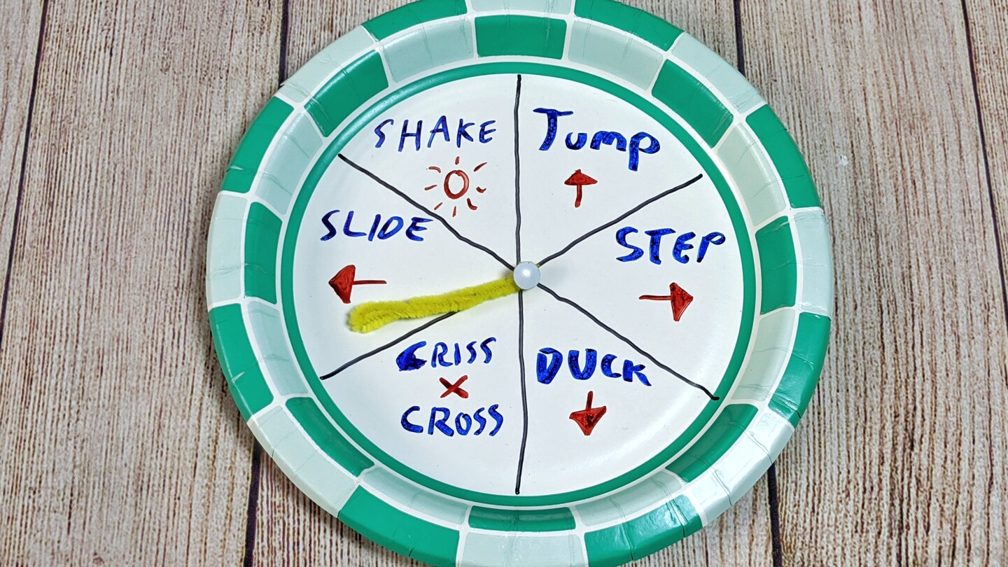 A paper plate spinner is divided and marked with instructions like step to the right, jump and duck.