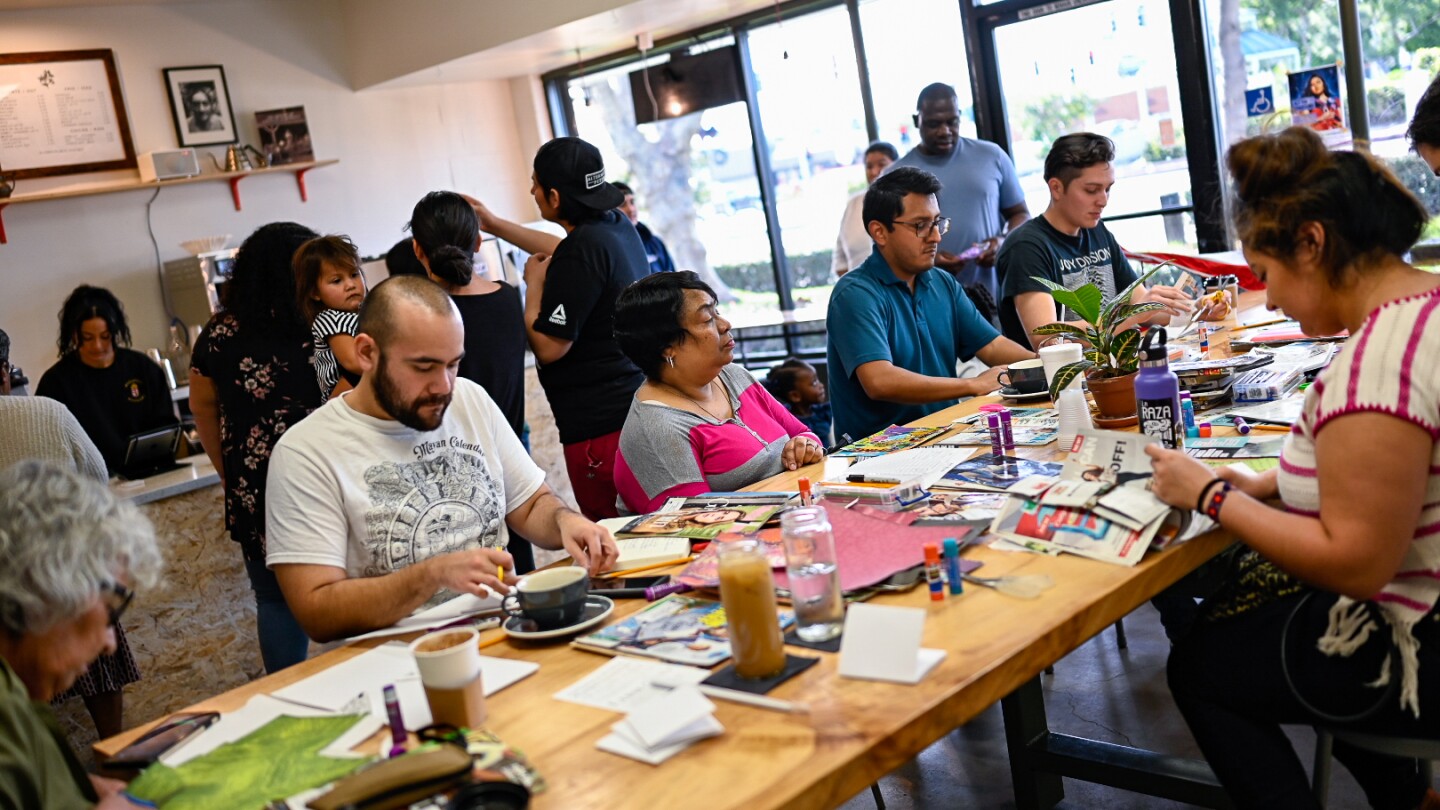 Participants make zines at a zine-making pop-up at Patria Coffee in 2018.