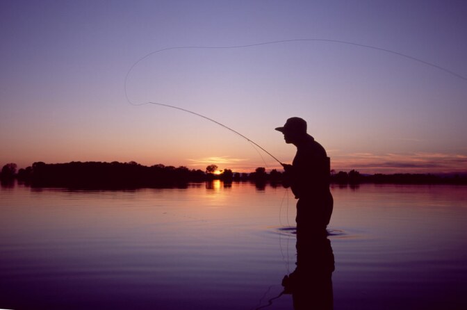 Wading Fisherman at Dusk