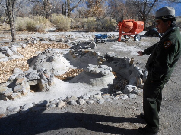 Manzanar superintendent Les Inafuku points out a recently excavated garden and koi pond, part of the active, dynamic nature of the historic site.