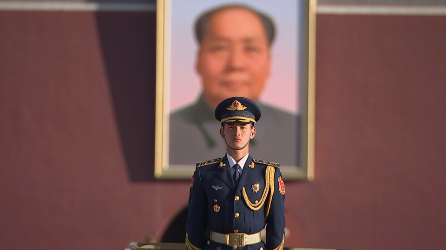 A Chinese soldier stands in front of a portrait of Mao Zedong in "Four Corners: Tremble and Obey."