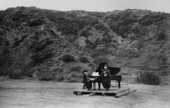 The first known performance in Daisy Dell took place in 1920. Pictured here are Gertrude Ross and Anna Ruzena Sprotte on a simple stage in the bowl-shaped canyon. Courtesy of the California Historical Society Collection, USC Libraries.