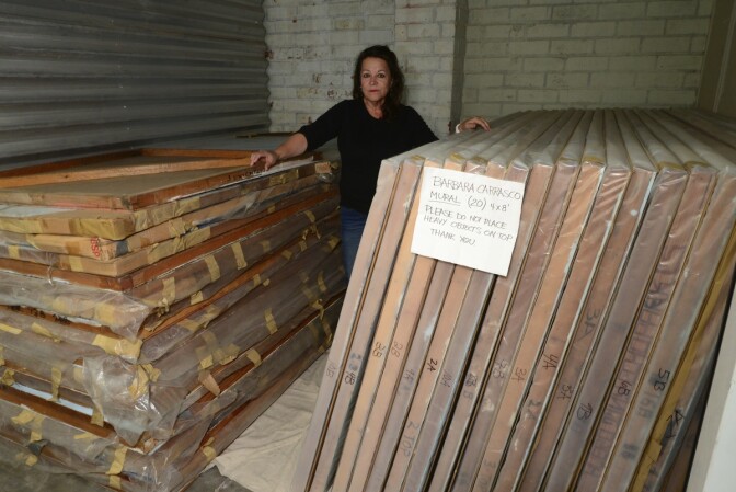Barbara Carrasco with panels of L.A. History in storage, 2016 | Oscar Castillo Murales Rebeldes