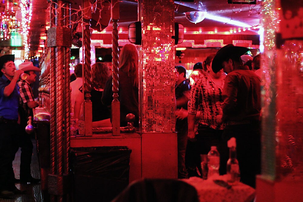 A busy dance floor and holiday decorations.