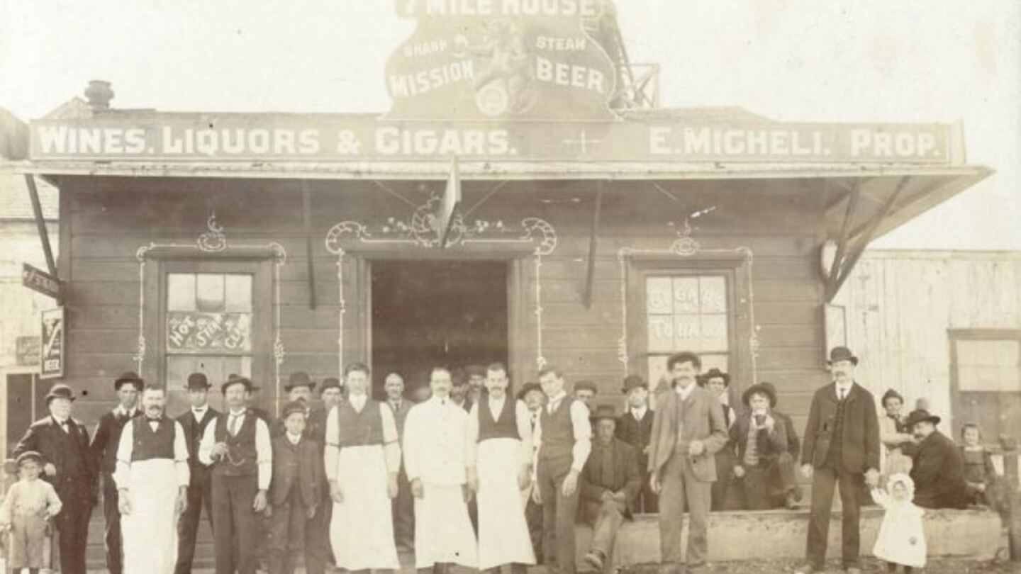 7 Mile House circa June 1904. Original owner, Egidio Micheli, center with apron, with partner, Palmiro Testa (right). Lady on the far right back holding baby Ecle is Niccola Testa. Little girl on far right is Eva Testa | Courtesy of 7 Mile House