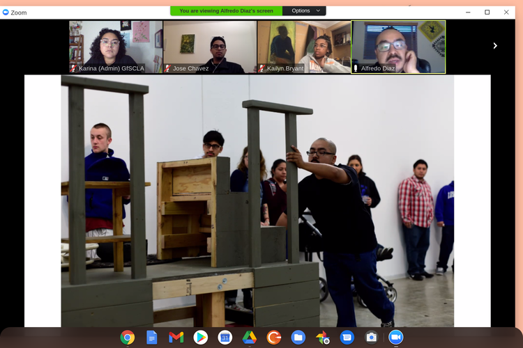 A Zoom screenshot presents a photo of artist Alfredo Diaz at work. Above the photo are small Zoom windows of various youth participants and Diaz in the top right corner.