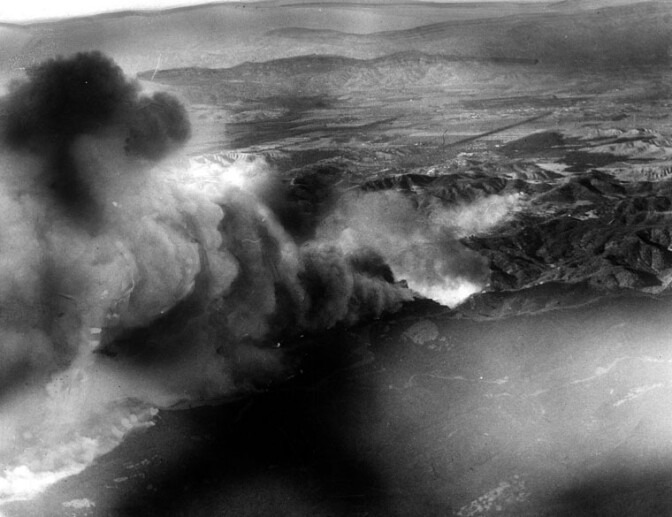 A brush fire, fueled by Santa Ana winds, sweeps through Topanga Canyon on Nov. 4, 1948, eventually claiming 25 homes. Courtesy of the Herald-Examiner Collection, Los Angeles Public Library.