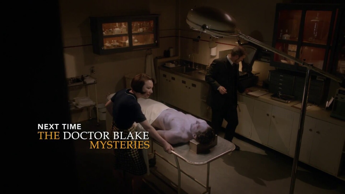 The Doctor Blake Mysteries Craig McLachlan in morgue with body on table and woman looking at it.