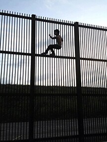 Child on border wall at Brownsville, Texas | public domain photo