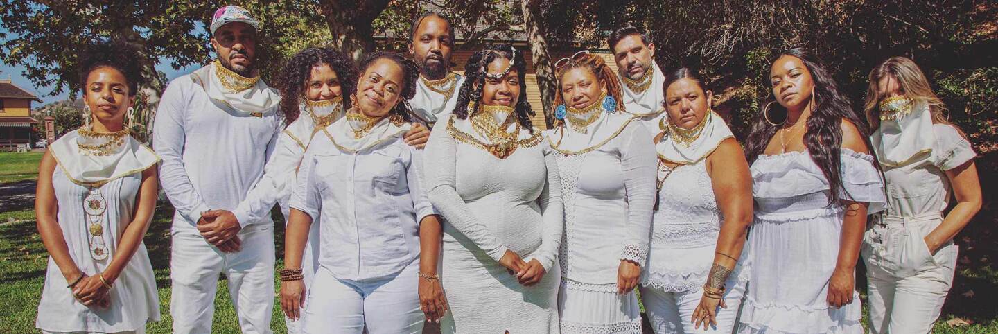 Voices of Creation members pose all in white. | Azul Amaral, Courtesy of Grand Performances