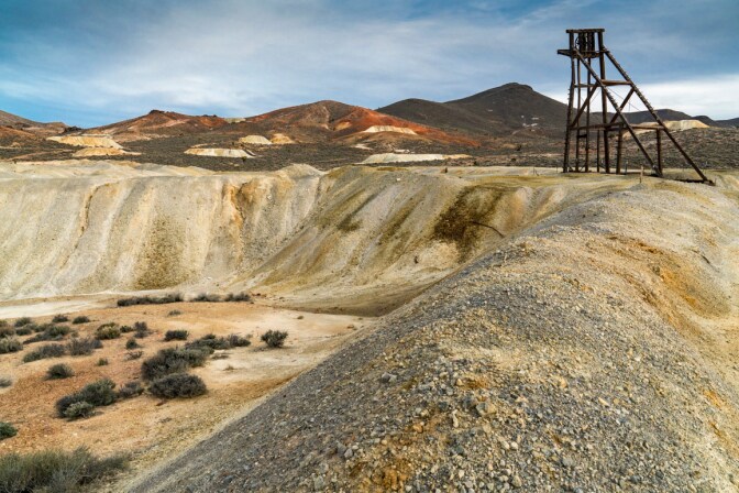A newly constructed headframe of a "hobby mine" with numerous historic Goldfield mines pictured in the distance. | Kim Stringfellow.