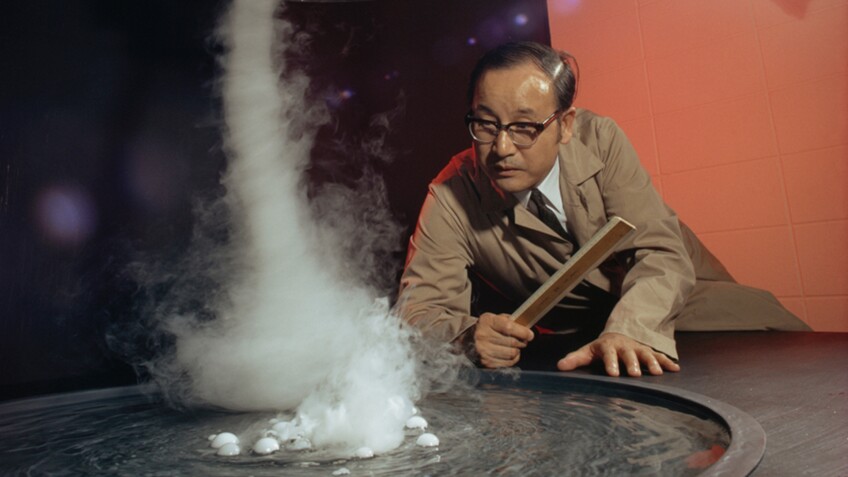 Pioneering meterologist Ted Fujita, or Mr. Tornado, is on the ground observing a small tornado. | "Mr. Tornado: American Experience"