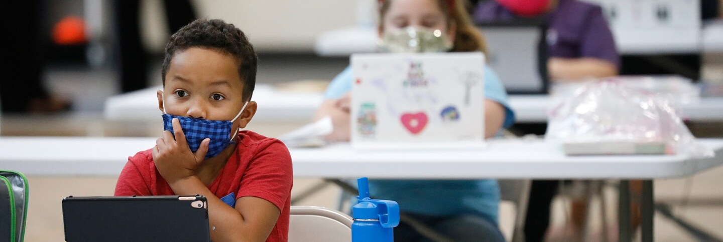 4th grade student Cameron Guidry focuses during his online class from his social distanced desk at the Delano Recreation Center in Van Nuys on Thursday, Sept. 3, 2020 in Los Angeles. | Al Seib / Los Angeles Times via Getty Images