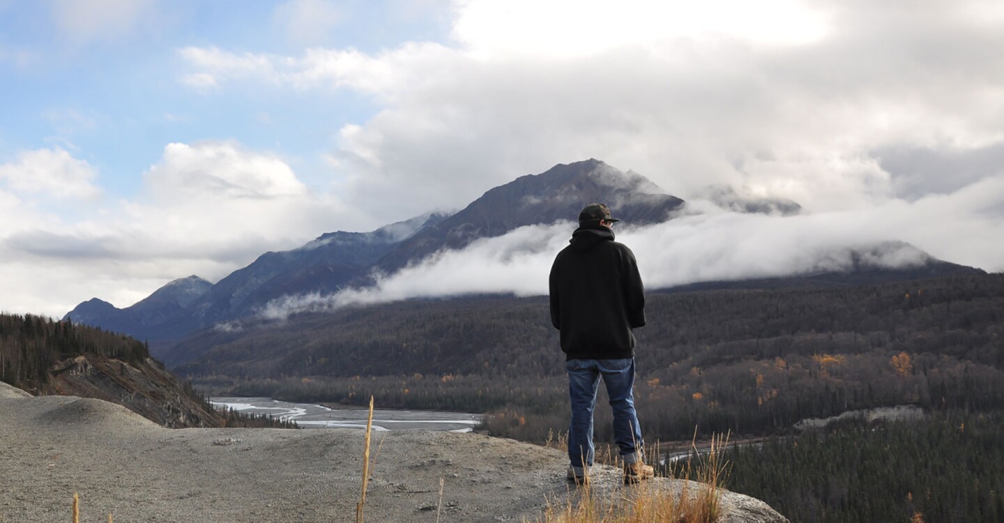 A man stands at an overlook.