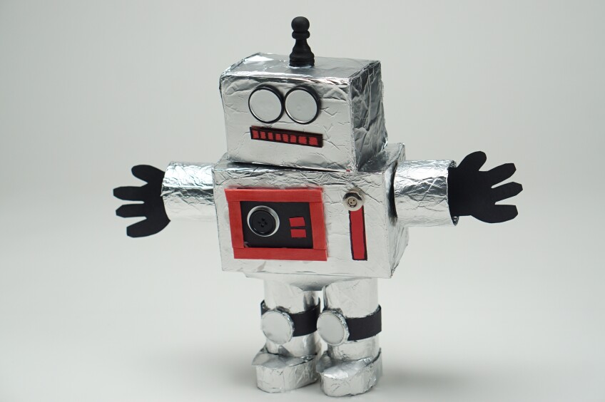 a  robot craft made out of boxes covered in aluminum foil decorated with various crafting materials