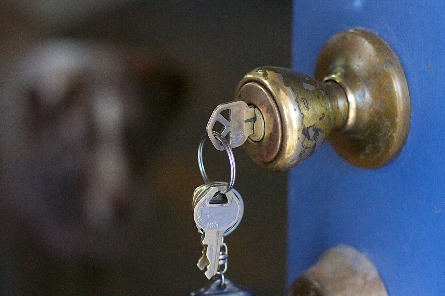 A keychain hangs from a lock on a doorknob.