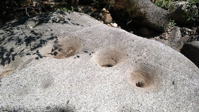 Bedrock mortars at Dinkey Creek. The existence of these and many other mortars demonstrates long-term Indigenous residence in a productive landscape. | Photo: Jared Dahl Aldern