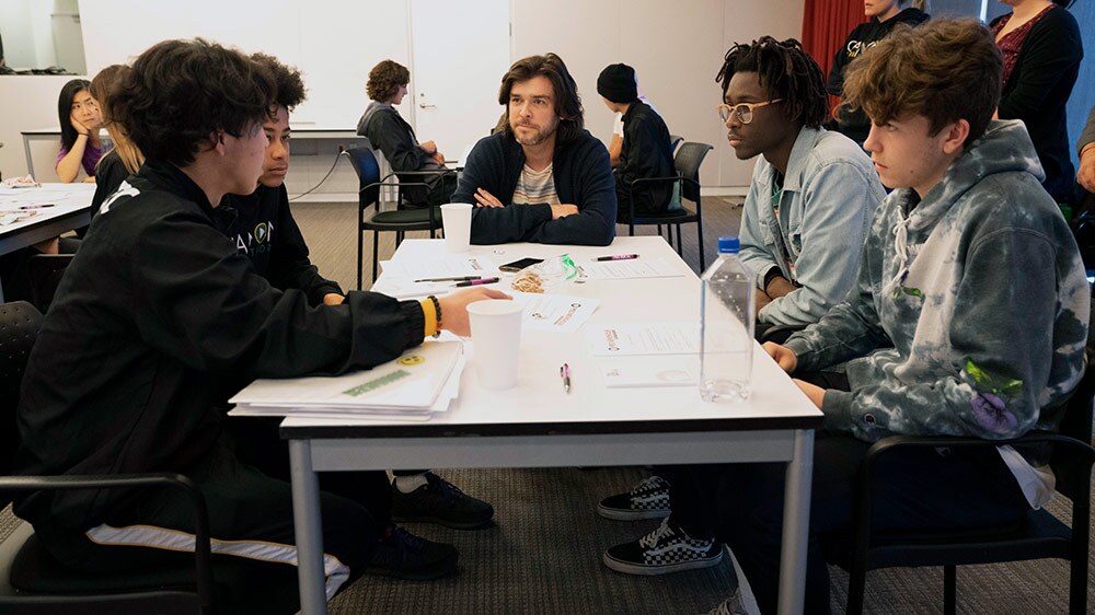 Students share their pitch ideas with Dan Leonard, an editor. | Carla Pineda