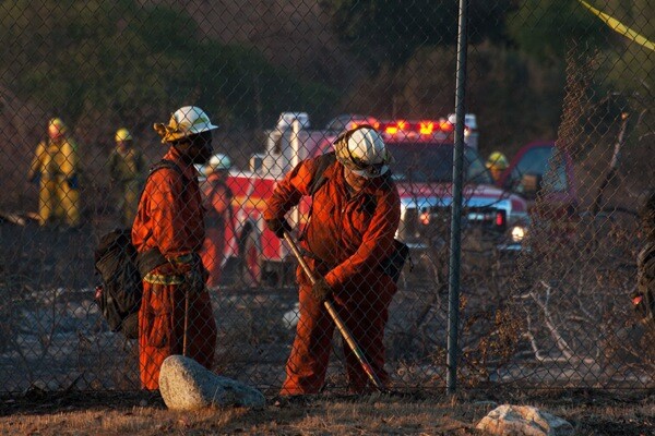 Firefighters work to extinguish a brush fire at Bernard Biological Field Station on September 11, 2013.