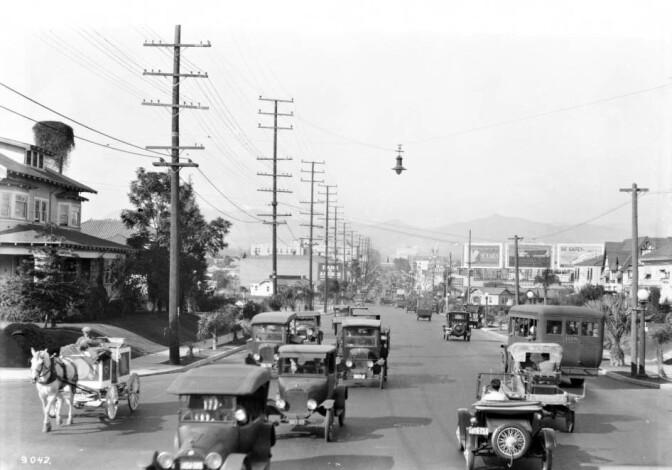 The urban horse survived well into the 1920s, but by the time of this circa 1924 photo horse-drawn vehicles were relegated to the edge of the Los Angeles roadway. Courtesy of the USC Libraries - California Historical Society Collection.