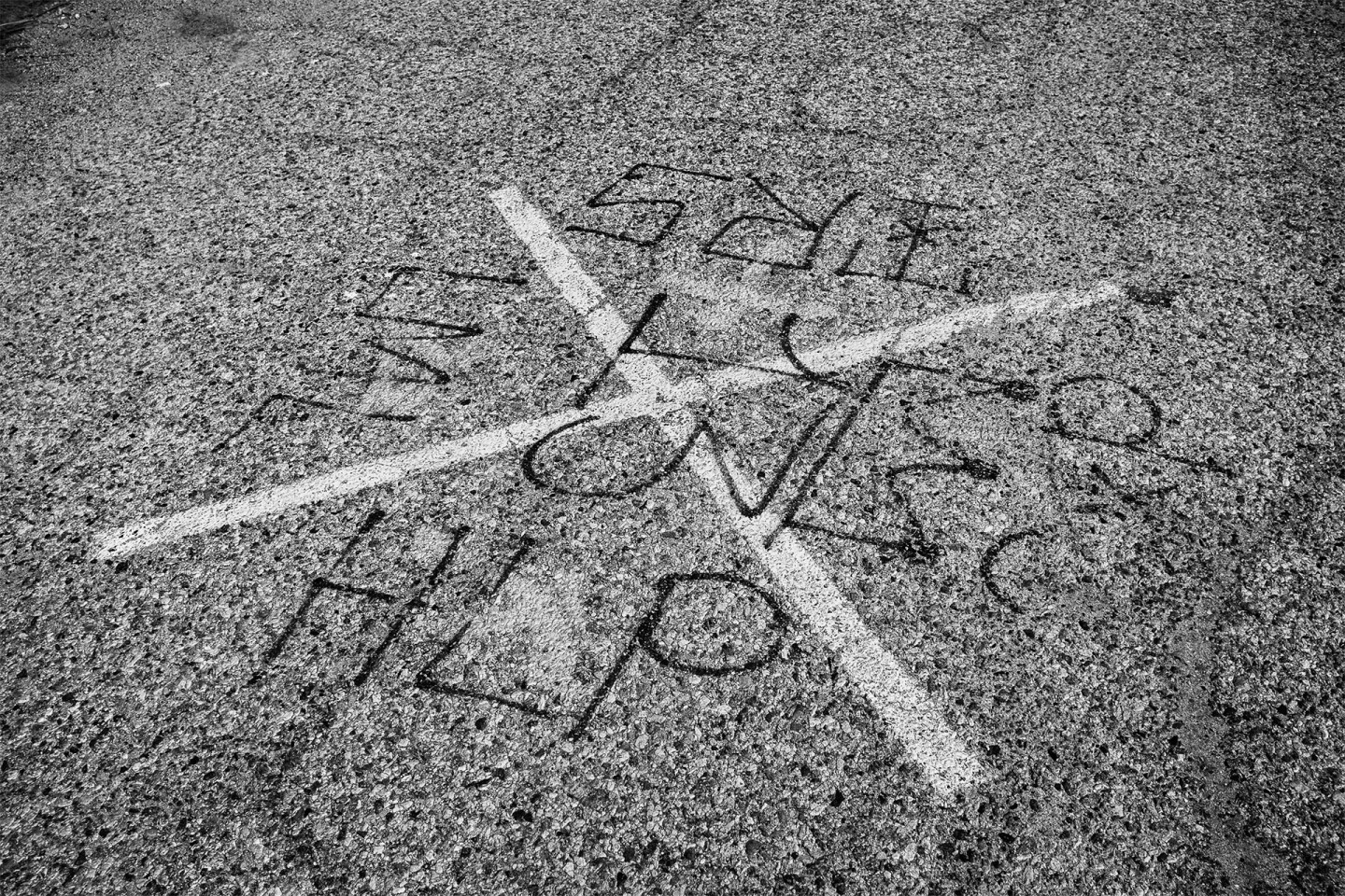 Tags on the ground at the Bowtie signify gang-related activity in the area | Photo by Bear Guerra