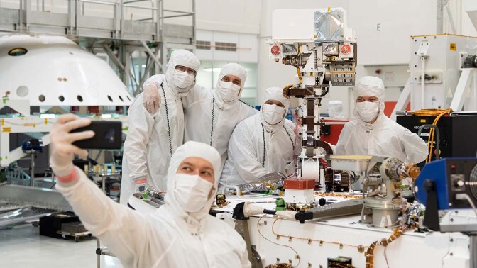 Members of NASA's Mars 2020 project take a moment after attaching the remote sensing mast to the Mars 2020 rover. | NASA/JPL-Caltech