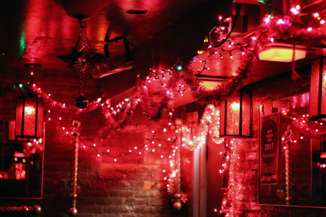 Holiday decorations: tinsel, lights, and a flyer for New Years Eve 2017.