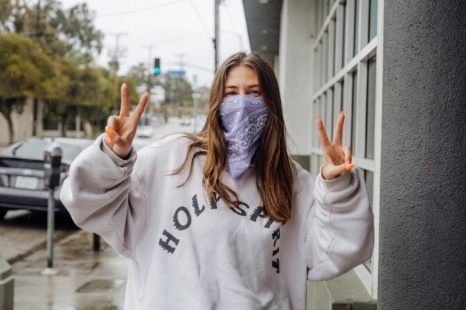 Olivia Mazurek says she almost forgot how to socialize and felt fear when interacting with people, but she feels it's important to at least acknowledge others as she takes walks so she'll throw up double peace signs as a greeting. | Chava Sanchez/LAist
