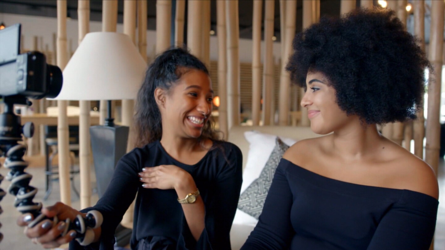 Chanwyn Southgate smiling with a friend. | Still from "Both Worlds"