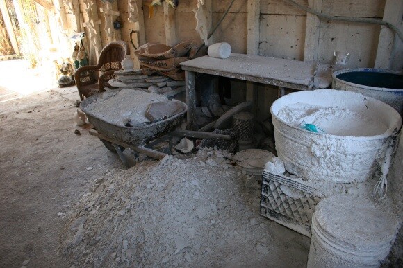 Containers with plaster and water surround a mound of remnants from broken pieces. The plaster/water mix is poured into molds to create various types of artisan pieces. | Photo: Misael Diaz.