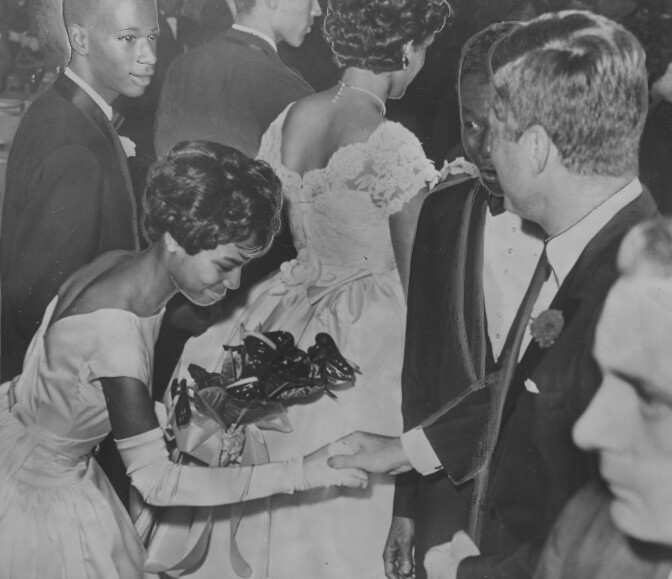 Nat King Cole And John F. Kennedy greet an African American debutante.