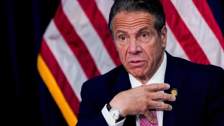 Andrew Cuomo gestures to himself.
