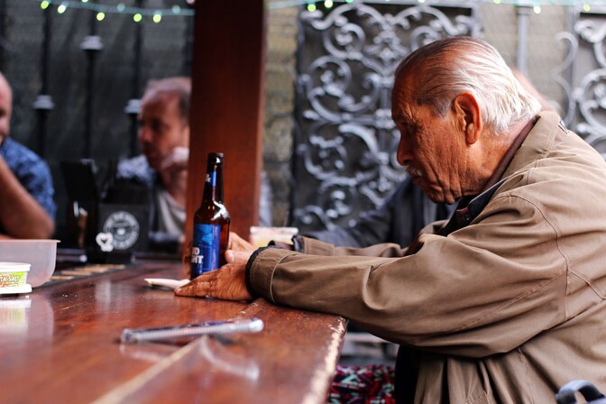 An older man sits at the La Cita bar with a Bud Light.